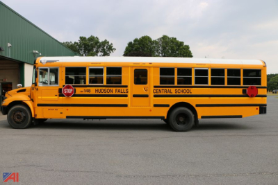 Yellow IC Corporation CE Series school bus with kids stop sign and Central School Hudson Falls, side view.