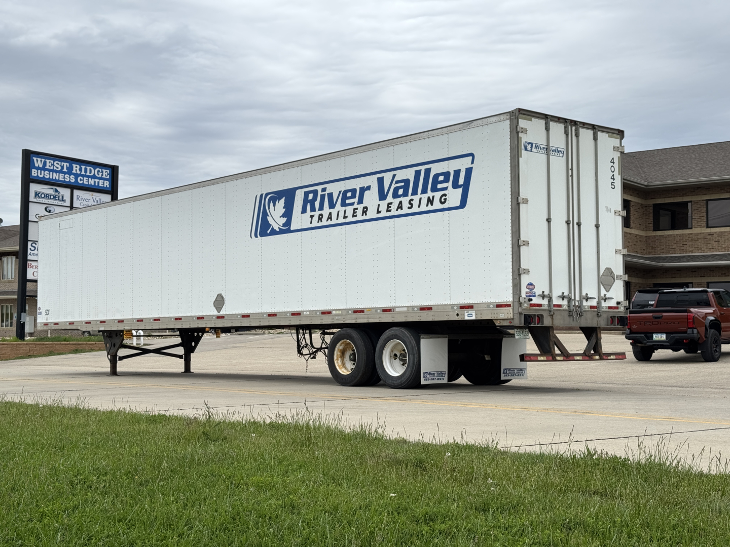 Trailer side with River Valley Trailer Leasing logo, white 53' dry van trailer, tandem axle, side text not legible.