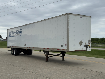 Trailer side and front showing River Valley Trailers logo on a white rectangular cargo trailer with dual rear axles and landing gear.