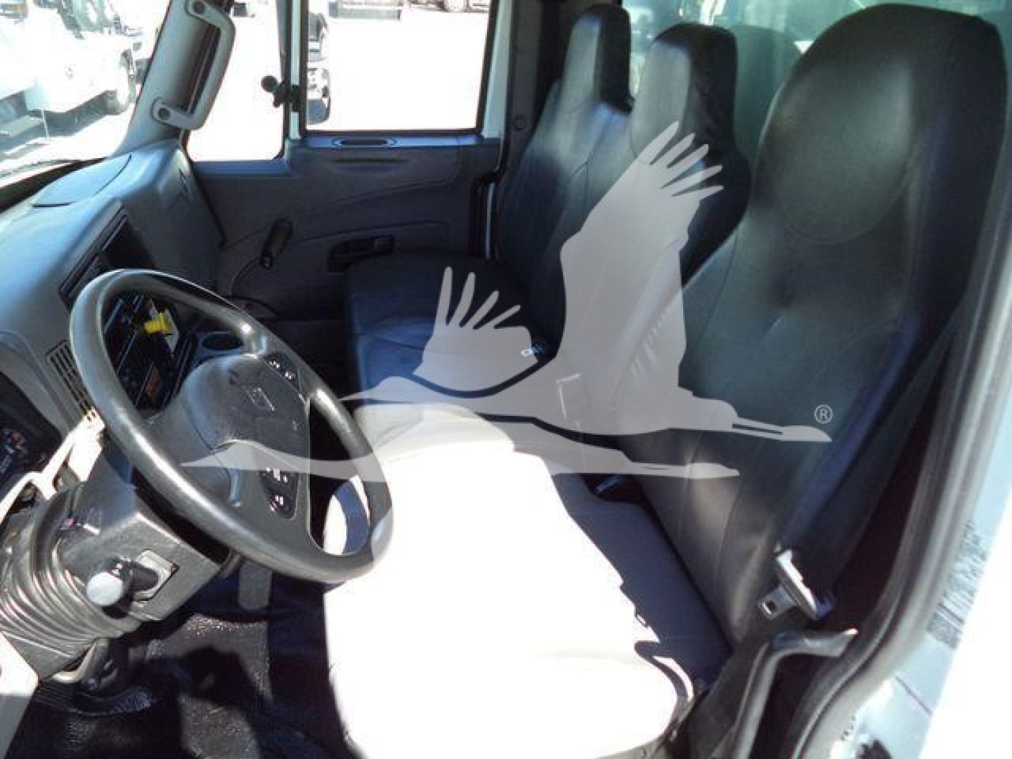 Interior of a 2019 International 4300 truck showing steering wheel, driver seat, and front passenger seat.