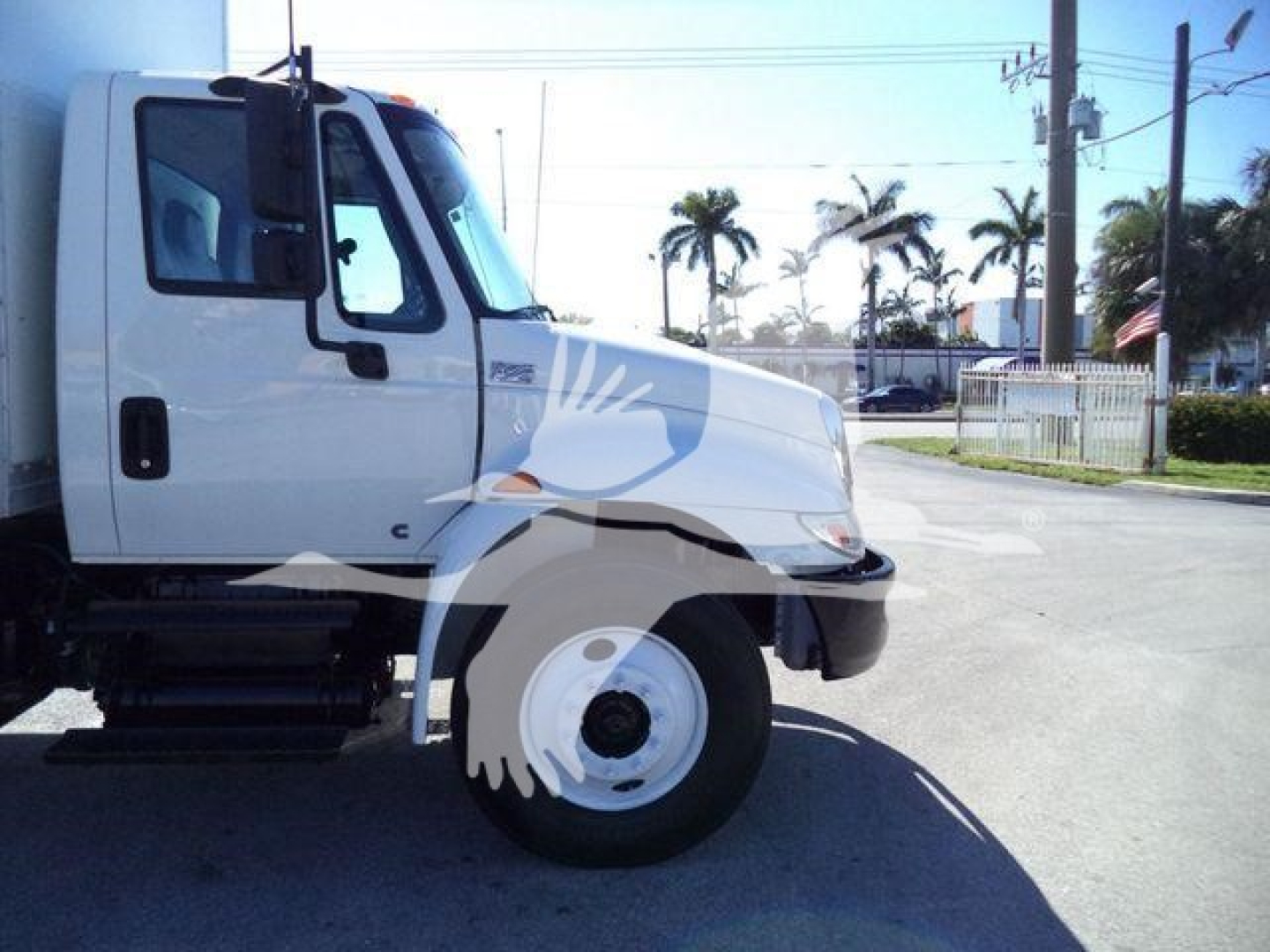 Truck front-left view of a 2019 International 4300 box truck showing the cab and front wheel.