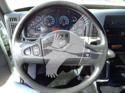 Truck interior steering wheel and dashboard of a 2019 International 4300 showing gauges and controls