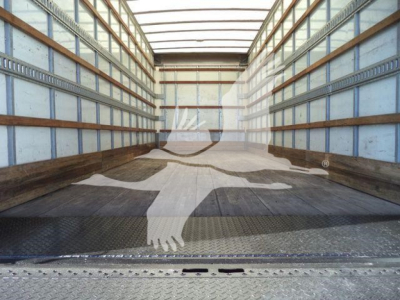 Interior of a box truck trailer with metal walls and wooden side rails, empty cargo area.