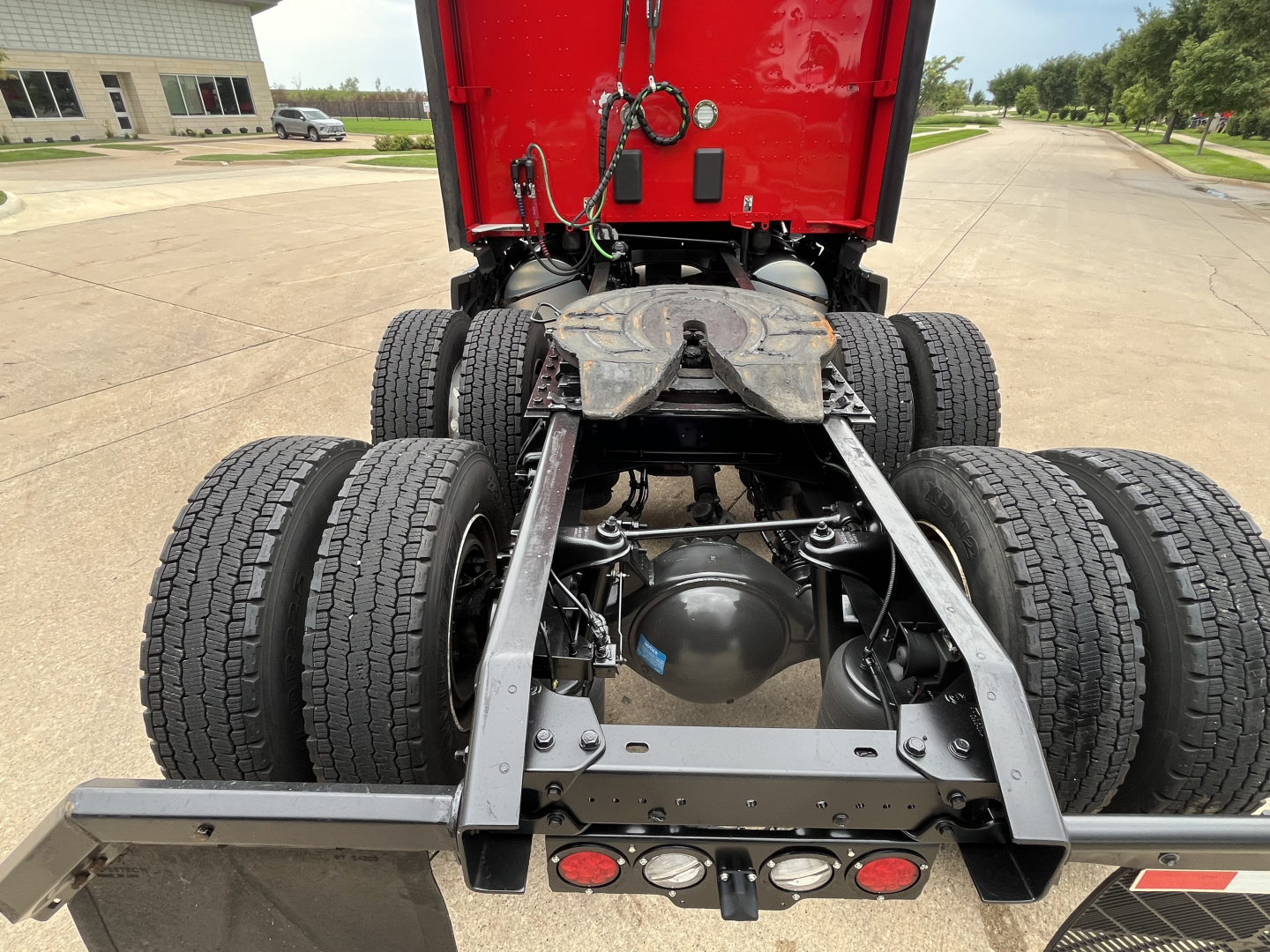 Kenworth T680 rear chassis showing dual rear axles and fifth wheel, with dual-tire arrangement and rear bumper lights.