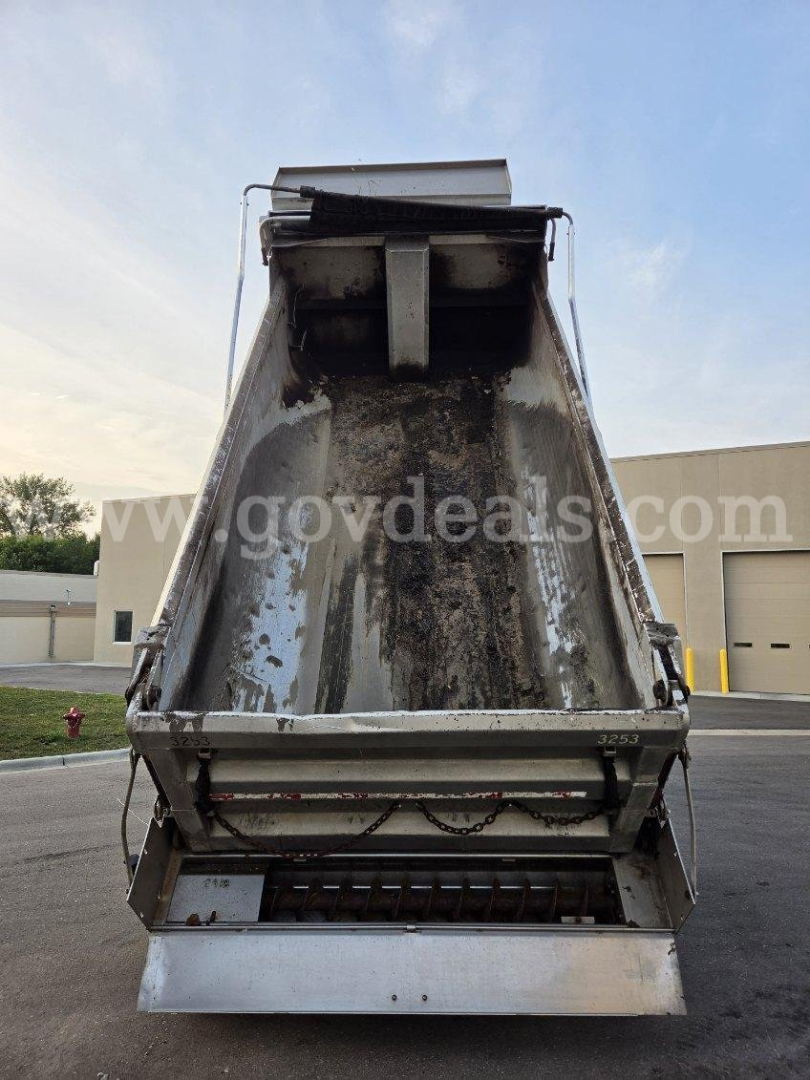 Dump truck bed of a 2007 International WorkStar 7600 with plow apparatus. Visible text includes faint website watermark and structural components of the dump bed.