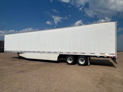 2014 Utility Van trailer side profile showing long white box with tandem axles and black wheels; no visible branding or text on the trailer.