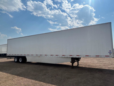 Trailer (box) side view showing utility van trailer with no visible branding and wheel axles in the distance.