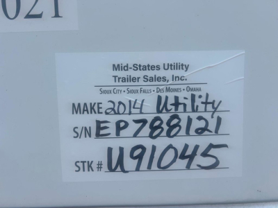 Tag on side of utility van showing Make 2014 Utility, S/N EP788121, STK # U91045, Mid-States Utility Trailer Sales, Inc.