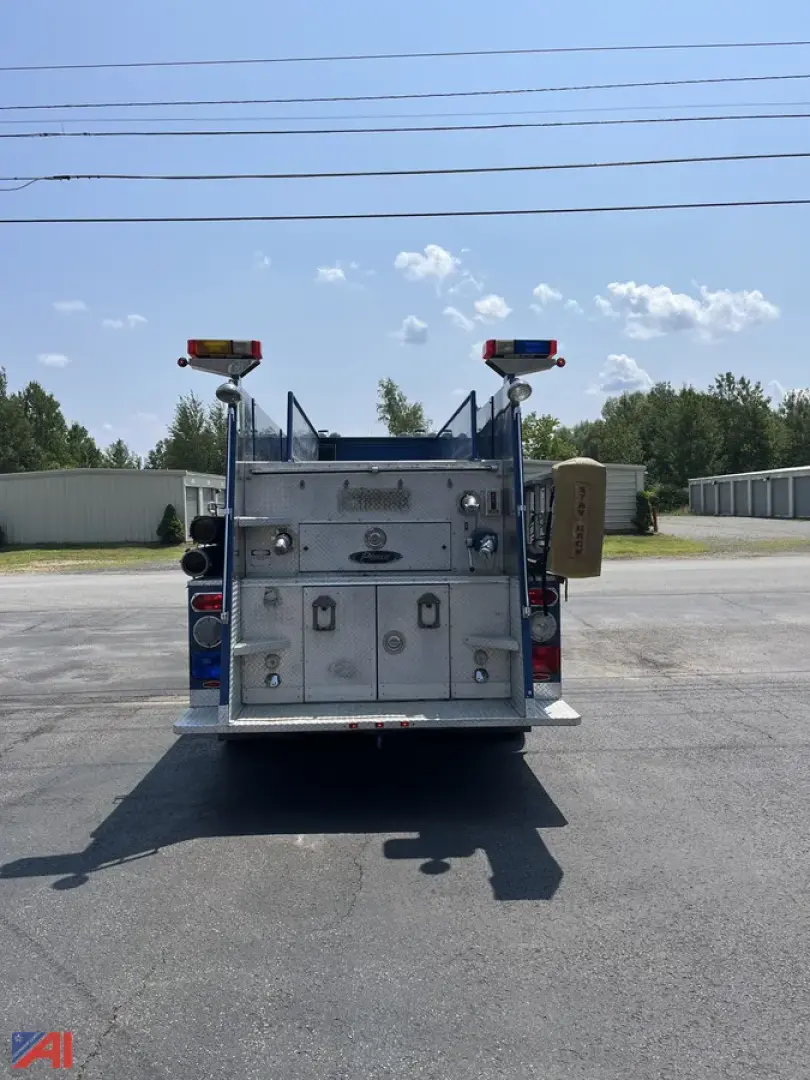 Back view of a Pierce Lance Pumper fire truck showing rear compartments and tail lights.