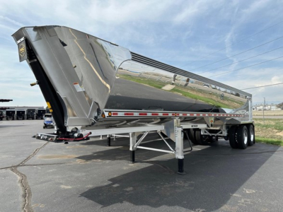 Mac Macsimiser 1/2 round aluminum end dump trailer with liner, silver finish, in-service on trailer legs and hitch.