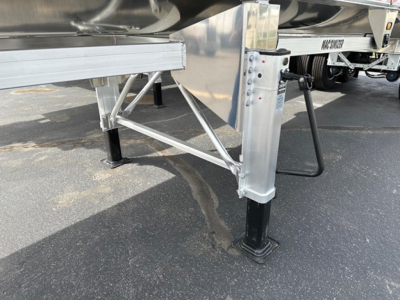 Mac Macsimiser 1/2 round aluminum end dump trailer with support legs and undercarriage components visible.