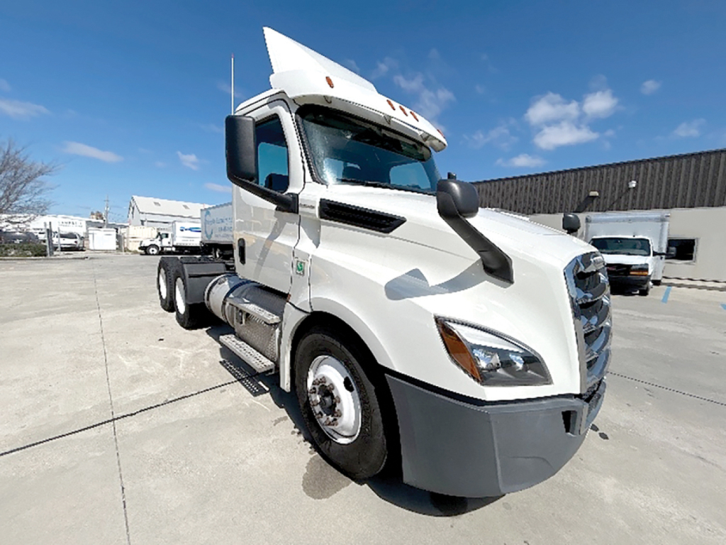 Freightliner Cascadia126 daycab truck in white, front-left view, with sleeper/cab area at top, parked on lot.
