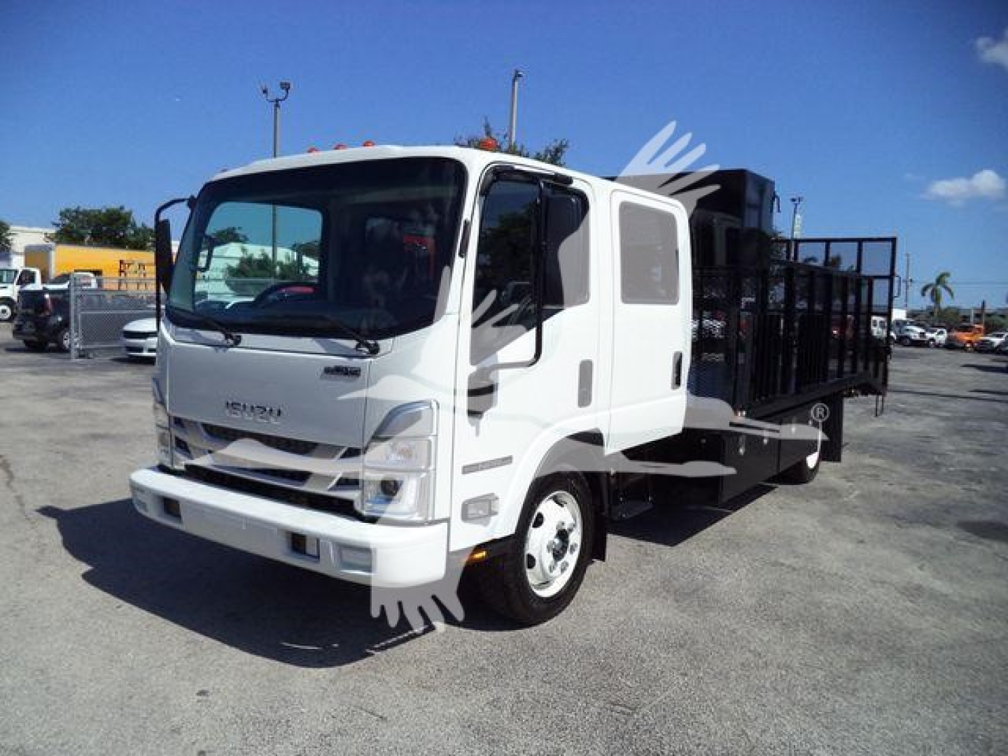 Isuzu NPR-Hd cab front and side view showing landscape body truck with open bed and metal ramp, white exterior.