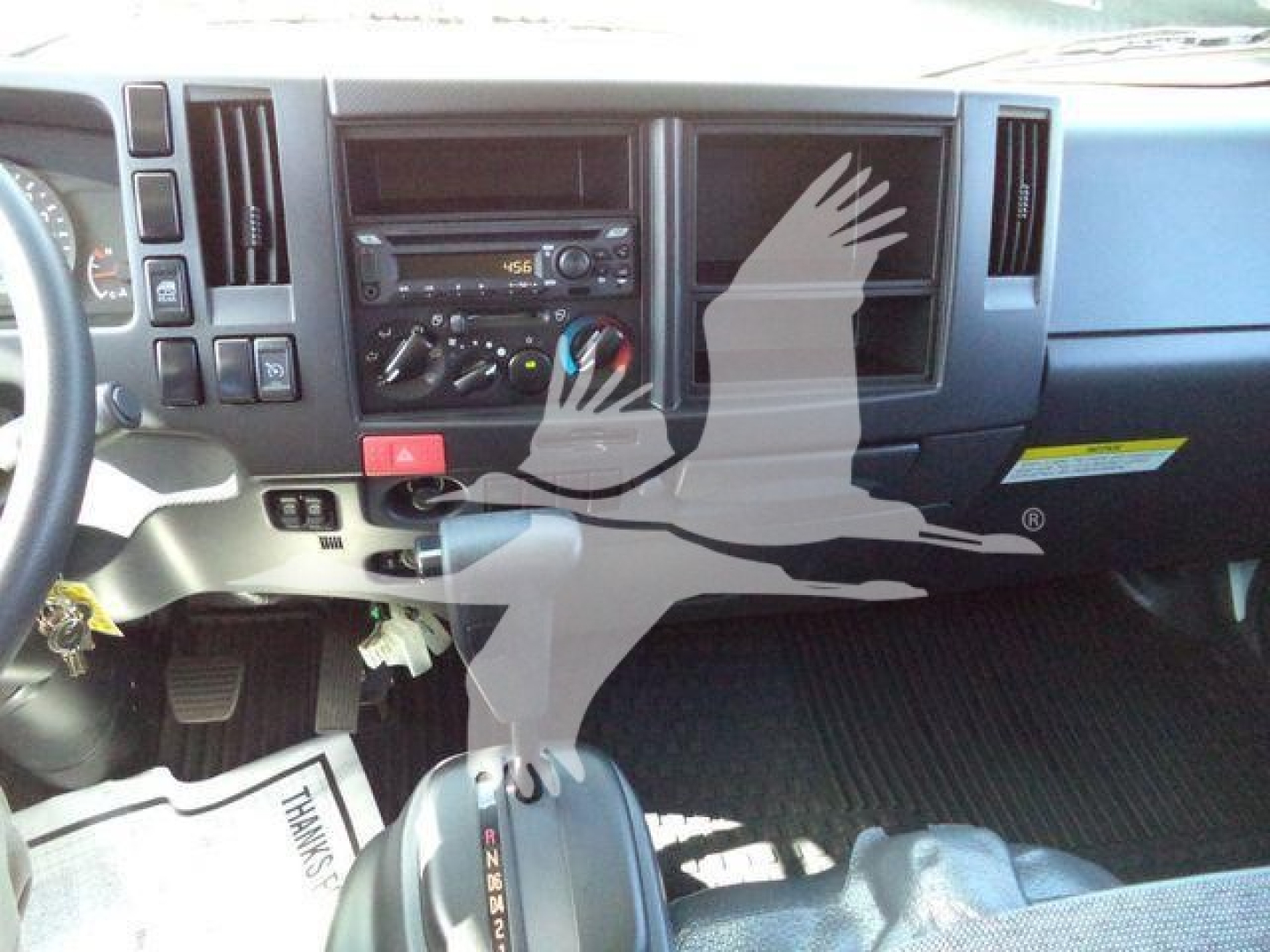 Isuzu NPR-HD truck dashboard and center console with gear lever visible.