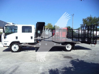 Isuzu NPR-HD landscape truck with flatbed and wheel-lift, side view showing white cab and black equipment bed, no visible branding text readable.