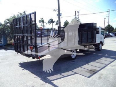 Isuzu NPR-HD truck with a large flatbed and a metal ramp/gate at rear; side shows cab and dump-style bed with black metal and white cab. The image contains no legible model text.