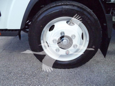 Isuzu NPR HD truck wheel and hub showing front wheel with white steel rim and black tire.