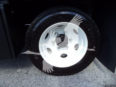 Isuzu NPR-HD truck wheel and tire in close-up showing white steel rim and black tire.