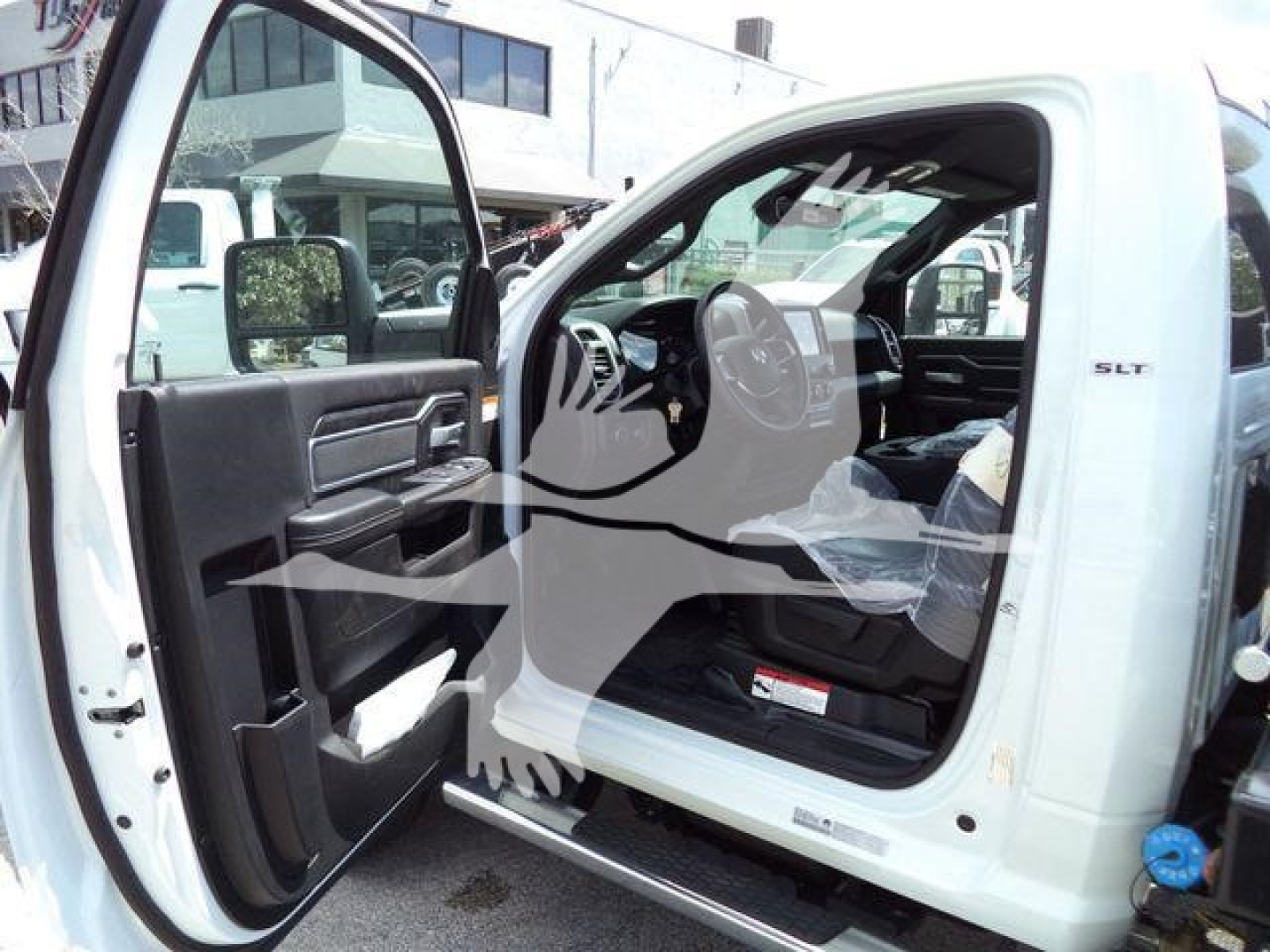 Ram 5500 SLT truck interior showing open driver door with steering wheel and dashboard visible.