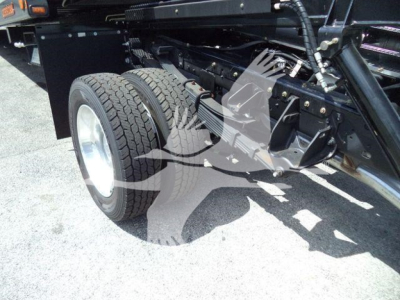 Ram 5500 rollback truck chassis showing dual rear wheels and hydraulic system components with tires and undercarriage.