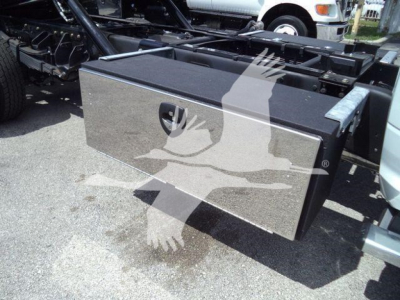 Storage toolbox mounted on truck frame with metal lid and latch, chrome finish.