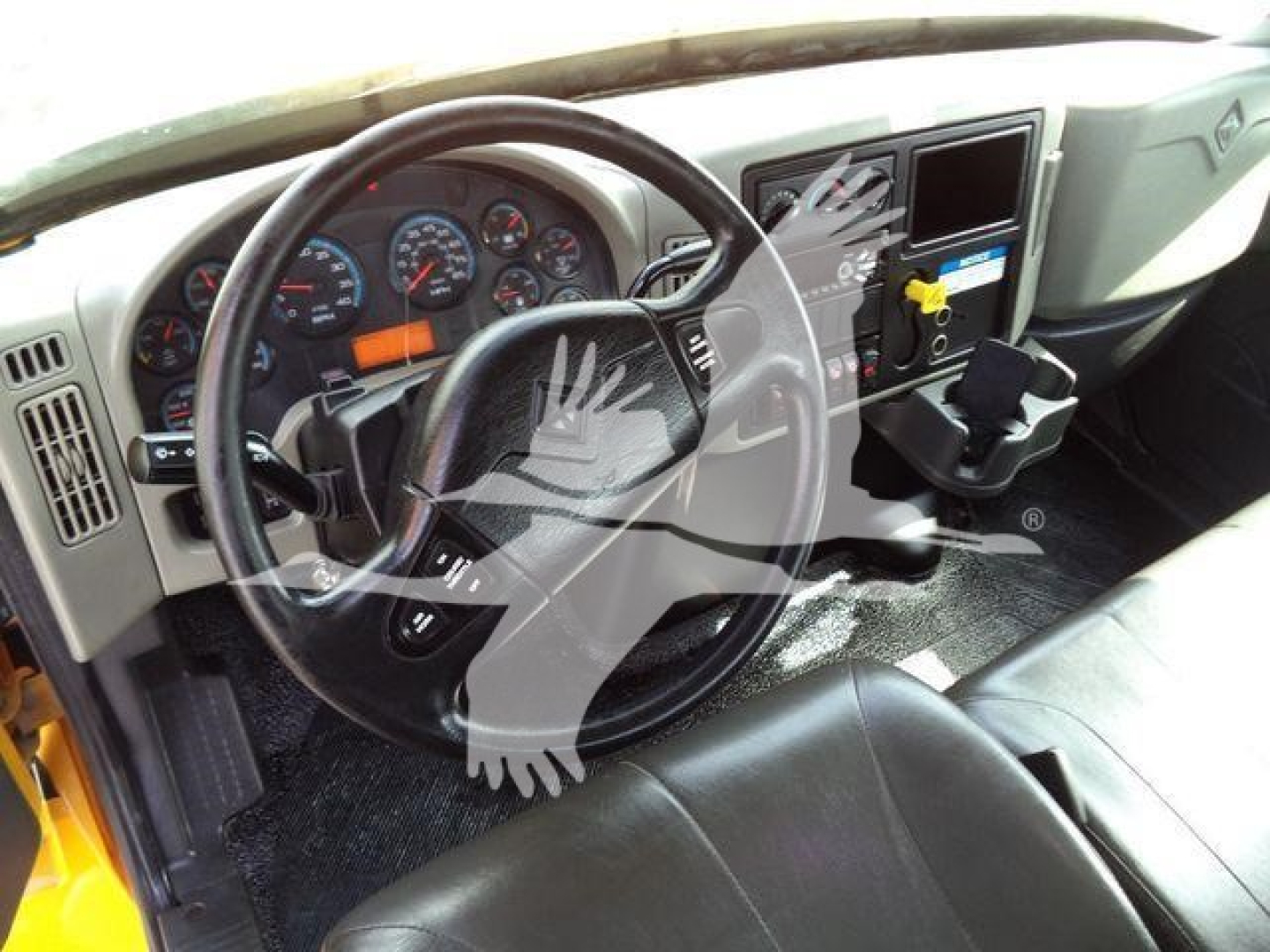 Truck cab interior of a 2019 International 4300 with steering wheel, instrument cluster, and center console visible.