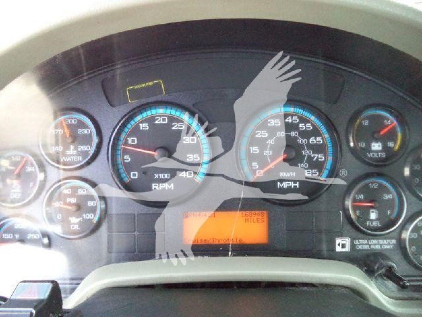 Dashboard gauges of a 2019 International 4300 rollback showing analog gauges and warning lights, with an orange digital/indicator readout in the center.