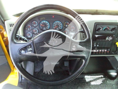Dashboard and steering wheel of a 2019 International 4300 roll-back truck showing instrument cluster and center console.