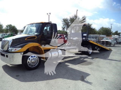 2019 International 4300 rollback truck in service position with tow bed extended, black and yellow color scheme, chrome front bumper, stock number T82488FM.