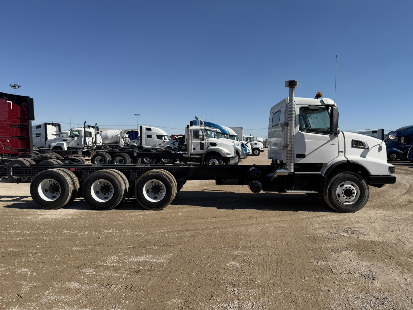 Volvo VHD86B300 cab and chassis showing long multi-axle frame and white cab.