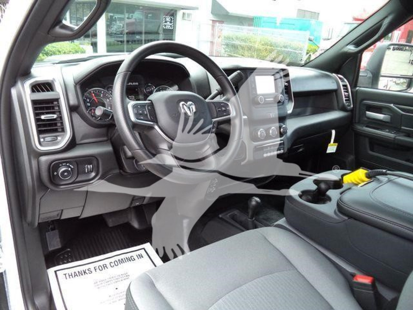 Ram 4500 interior view showing steering wheel, dashboard, center console with touchscreen, and front seats; pickup truck cabin with protective watermark.