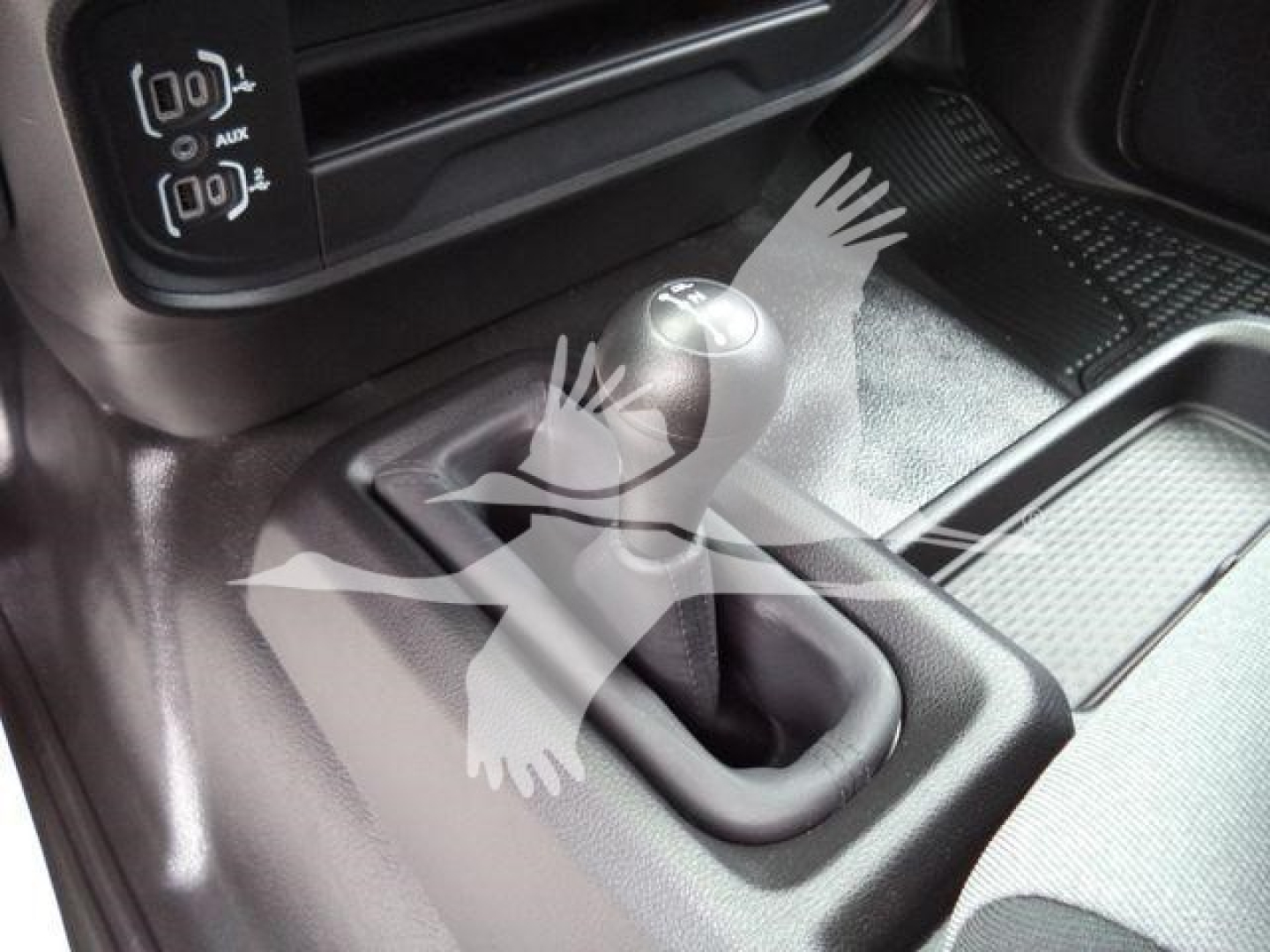 Ram 4500 interior showing gear shifter and center console with 4x4 buttons and aux ports.