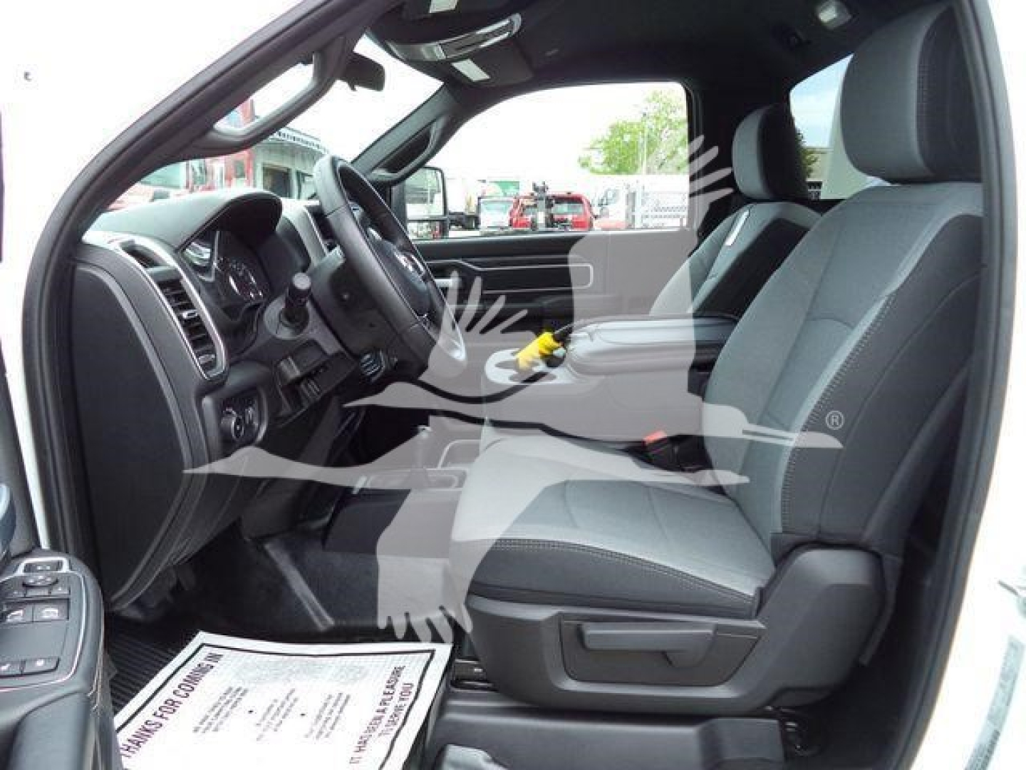 Ram 4500 SLT front cab interior view showing driver seat and passenger seat with steering wheel and center console.