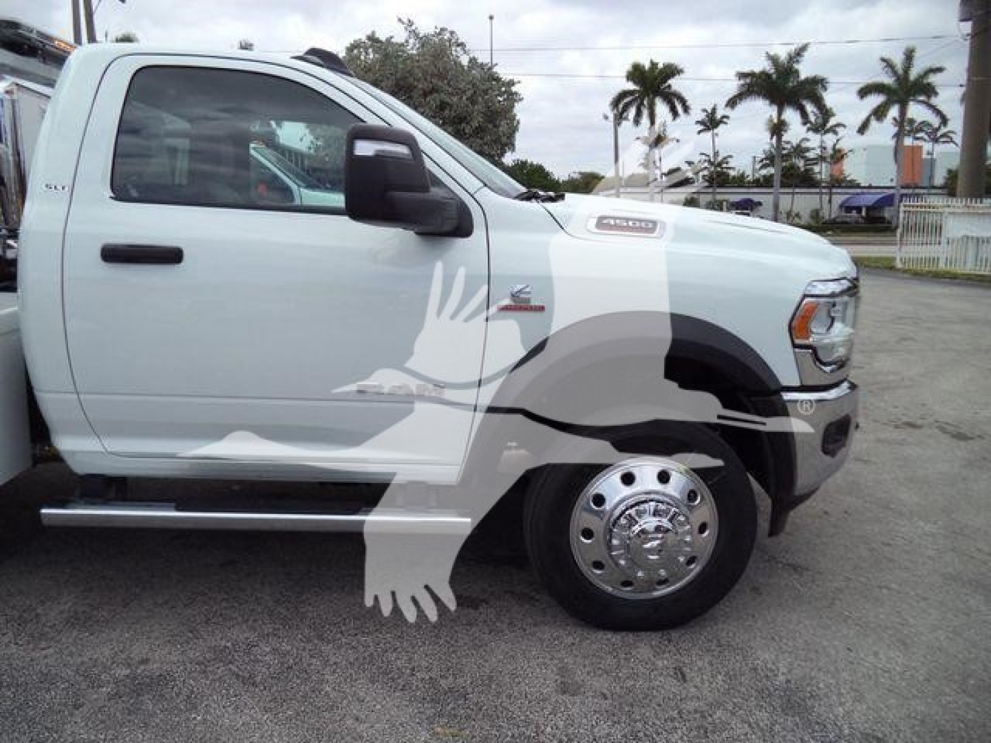 Truck side profile showing a white 2024 Ram 4500 SLT with Winch category signage, large chrome wheel, and side step; stock number J98304FM visible.