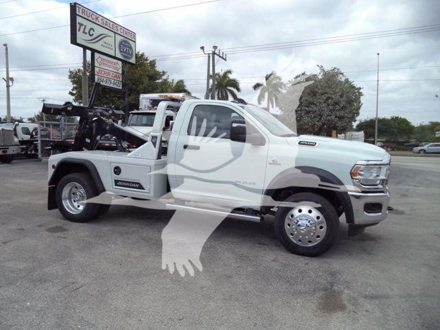 RAM 4500 tow truck side view with winch mounted behind cab. Side mirrors, dual rear wheels, chrome hubcaps. Fleet branding not legible.