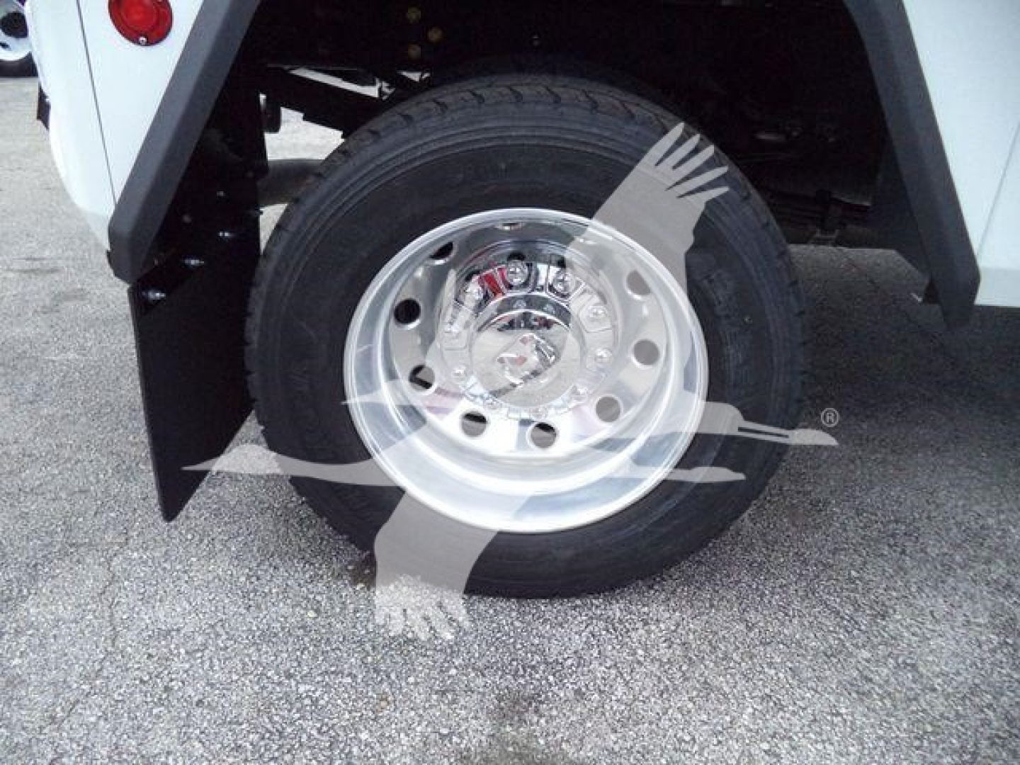 Wheel and tire of a Ram 4500 SLT front with polished aluminum rim and black tire under fender, part of winch-equipped truck.