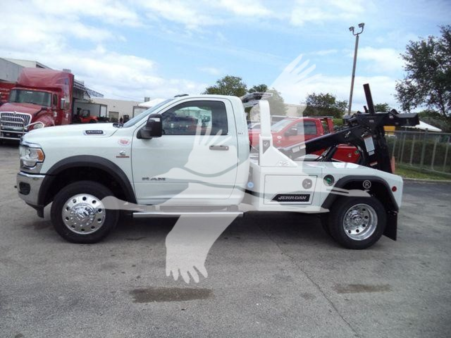 Ram 4500 tow truck with winch on rear and white cab, side view, stock number J98304FM.