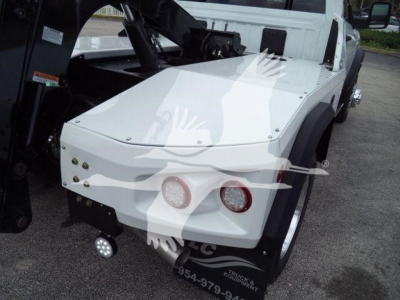 Ram 4500 SLT pickup with winch gear in front, white body panels, round taillights, and heavy-duty bumper.