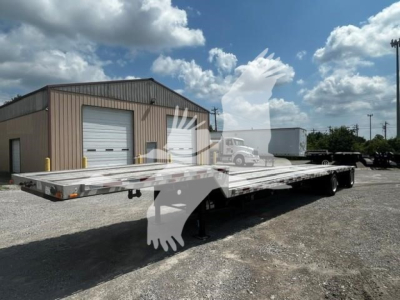 Transcraft DTL-2000 drop deck trailer in serviceable condition with long flatbed and multiple axles.