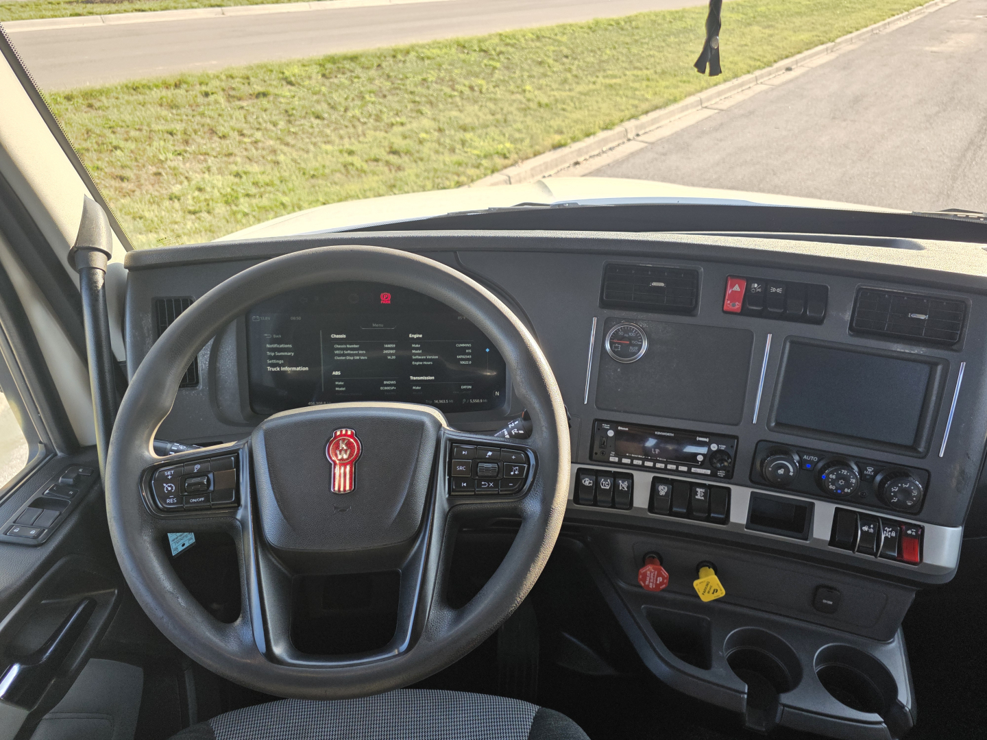 Kenworth T680 cab interior/dashboard with steering wheel and controls; view shows steering wheel with Kenworth emblem and instrument cluster.