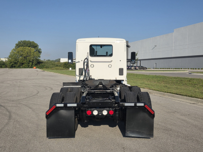 Kenworth T680 rear view showing chassis, dual rear axles, and fifth wheel attachment points with mud flaps.