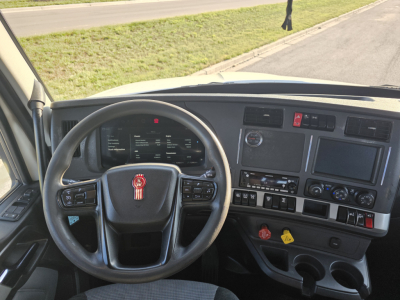 Kenworth T680 cab interior/dashboard with steering wheel and controls; view shows steering wheel with Kenworth emblem and instrument cluster.