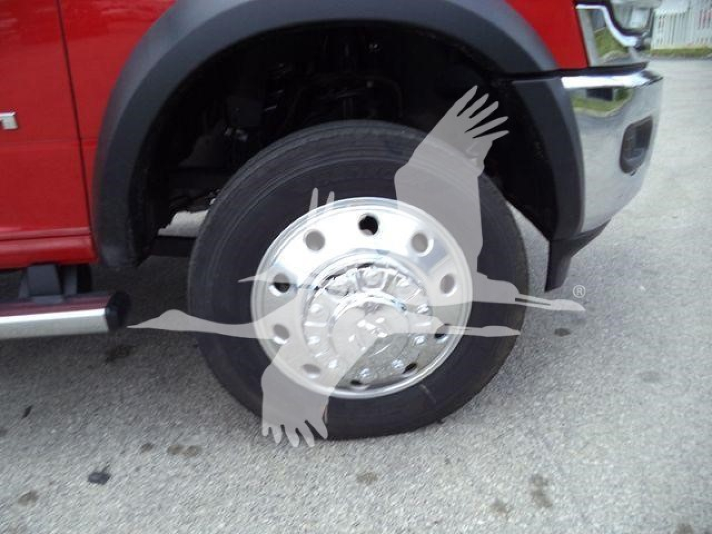 Ram 4500 front wheel and fender area showing wheel with chrome hub, tire, and partial fender; no visible text readable besides brand implied by vehicle design.