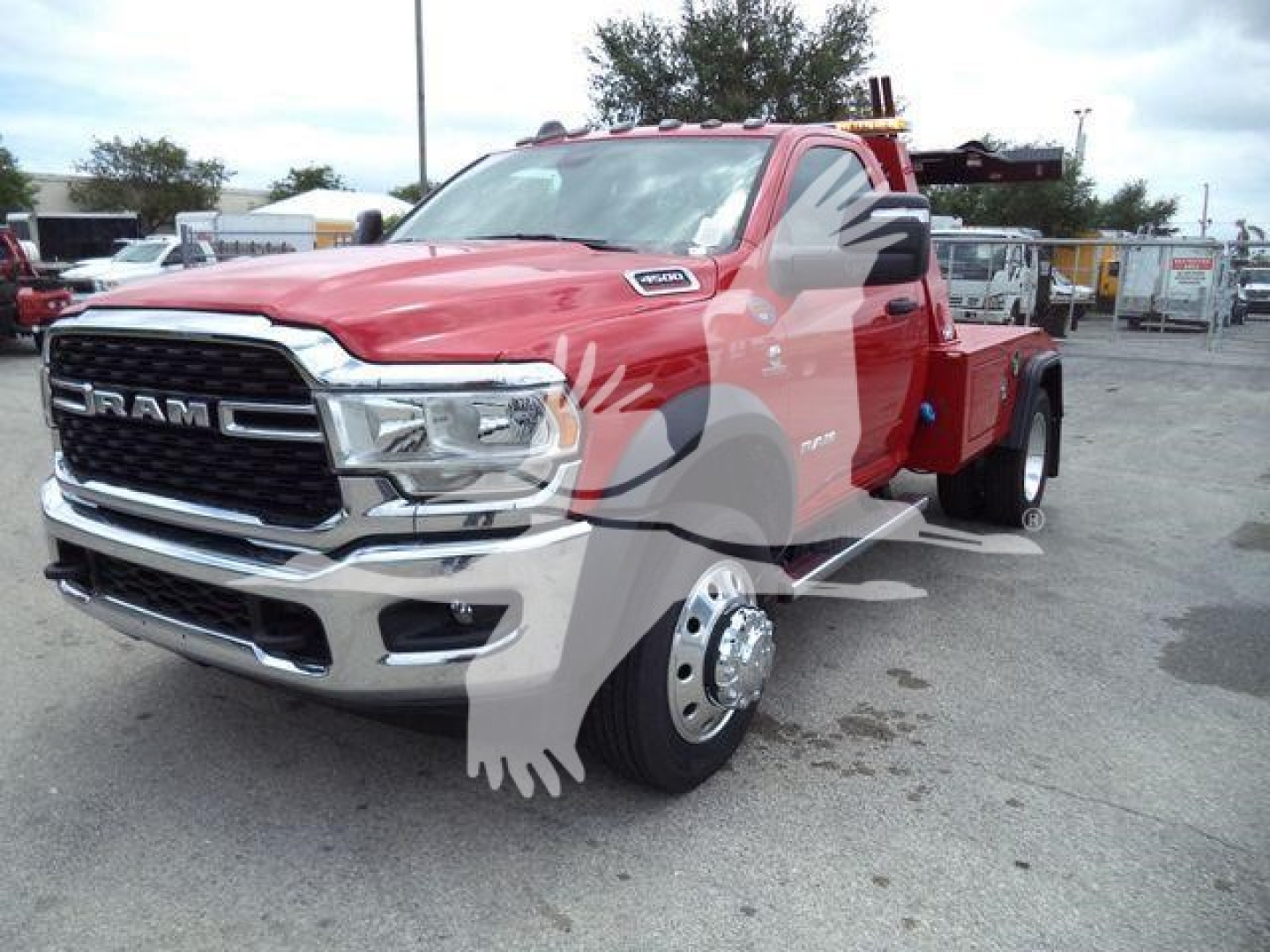 Ram 4500 SLT tow truck/flatbed showing front grille, chrome bumper, RAM badge, and dual rear wheels with white lettering.