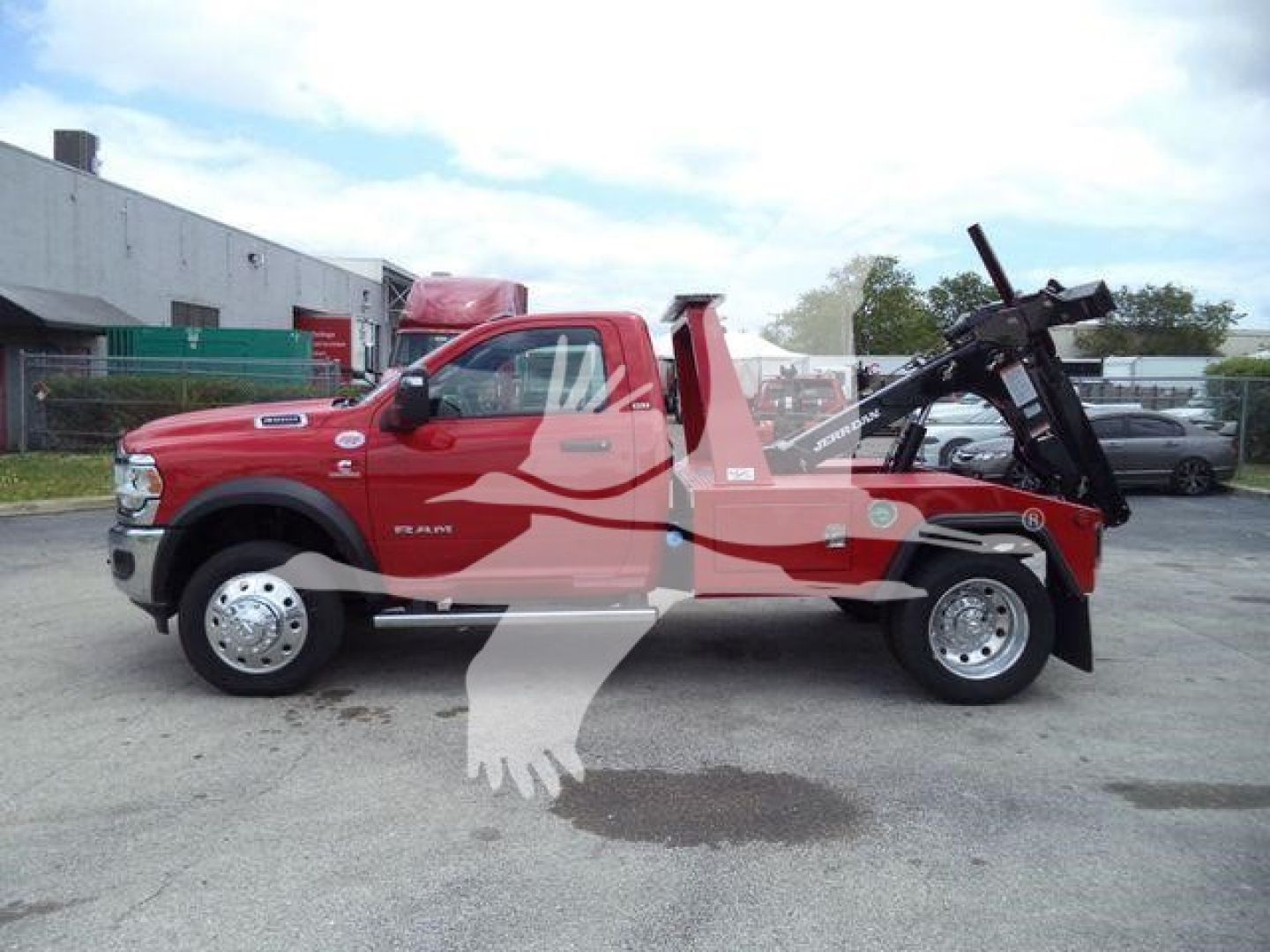 2024 Ram 4500 SLT single cab tow truck with crane/winch equipment in bed, side view showing front doors, tires, and wheel wells.