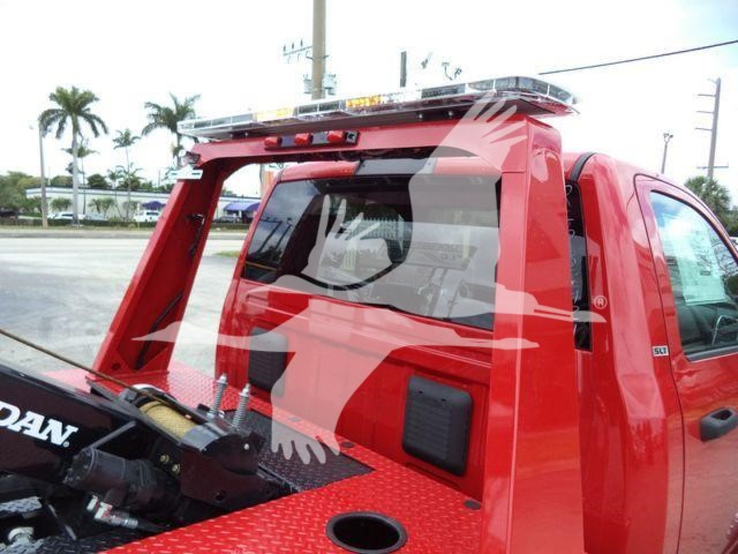 Ram 4500 SLT pickup with red winch truck bed and hoist, side view showing crane/boom mounted at rear with winch mechanism.
