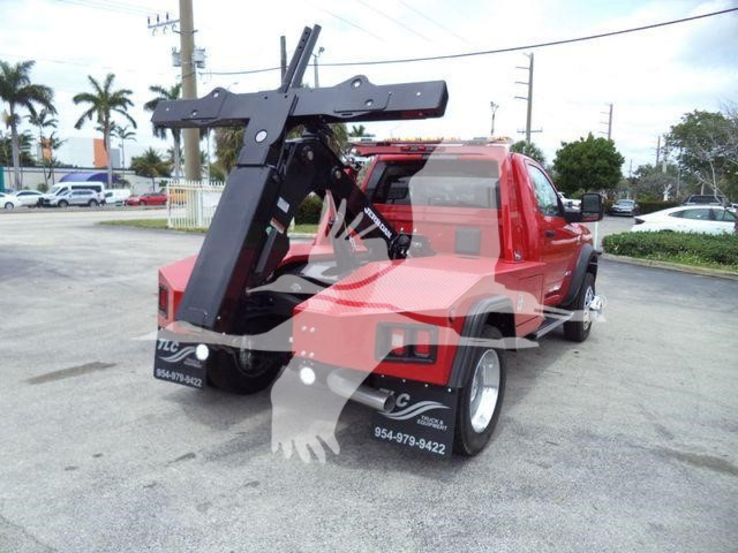 Ram 4500 SLT pickup truck with a mounted heavy-duty winch/crane attachment at the rear, red cab and bed, visible stock number J82921FM in a dealership lot.