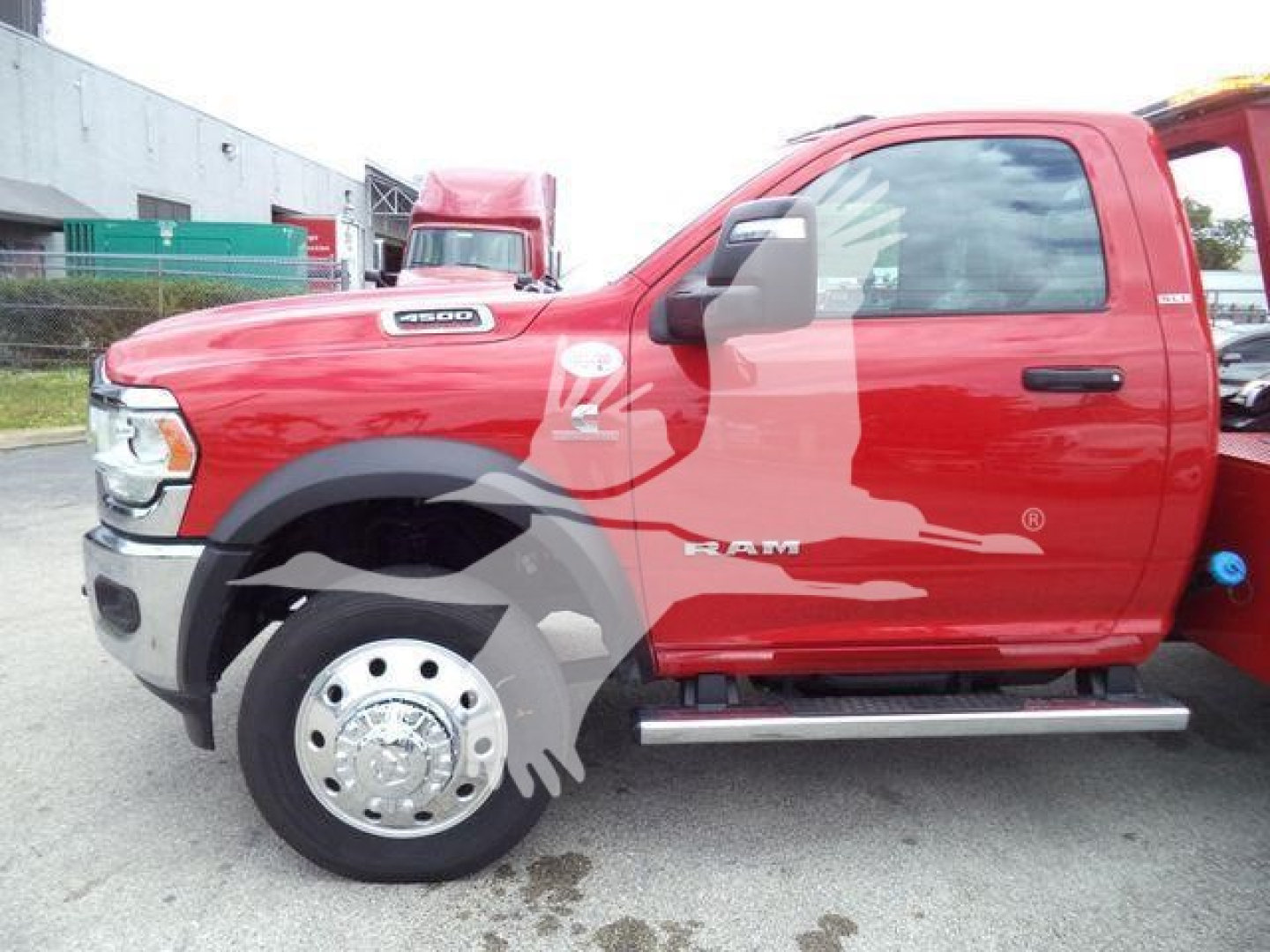 Ram 4500 truck side view showing cab and front fender with Ram logo and chrome wheel hub; red paint with black fender, side step, and model badge.