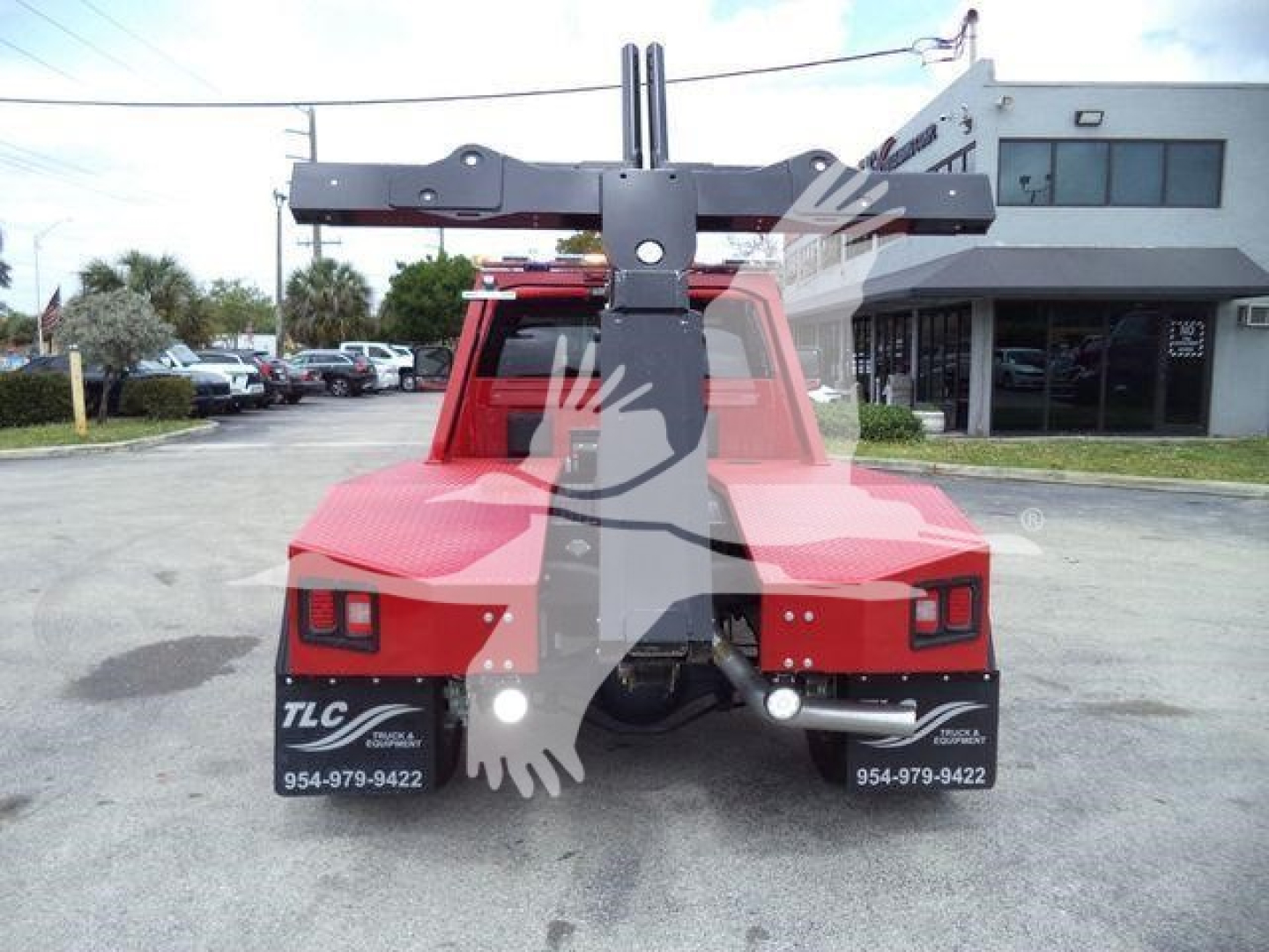 Rear view of a red Ram 4500 truck with a large hydraulic winch gantry mounted on the bed, showing dual rear taillights and bumper numbers.
