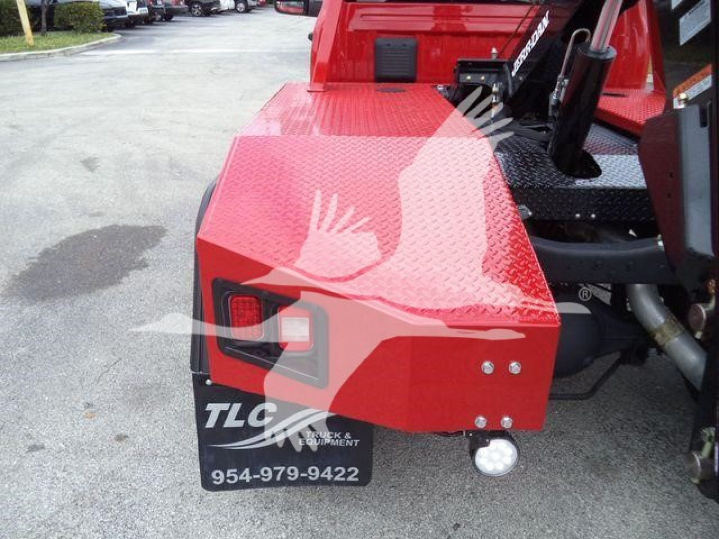Front-left rear view of red Ram 4500 winch truck showing rear bumper with TLC Truck & Equipment logo and contact number 954-979-9422.